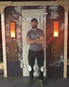 Jason Kaufman standing in front of what is Mrs. Lovett's oven for Sweeney Todd